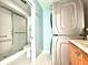 Main bathroom with shower, toilet, and stacked washer/dryer at 4375 Tahitian Gardens Cir # B, Holiday, FL 34691