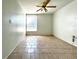 Bright living room featuring tile flooring and a ceiling fan at 4375 Tahitian Gardens Cir # B, Holiday, FL 34691