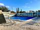 Community pool with lounge chairs and patio area at 4375 Tahitian Gardens Cir # B, Holiday, FL 34691