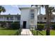Condo building entrance with elevator access and landscaping at 4746 Azalea Dr # 209, New Port Richey, FL 34652