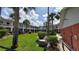 Residential building with palm trees and green lawn at 4746 Azalea Dr # 209, New Port Richey, FL 34652