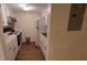 Efficient galley-style kitchen with white cabinets and appliances at 4746 Azalea Dr # 209, New Port Richey, FL 34652