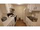 Small kitchen with white cabinets, appliances, and double sink at 4746 Azalea Dr # 209, New Port Richey, FL 34652