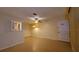 Living room with tile floors and a view into kitchen area at 4746 Azalea Dr # 209, New Port Richey, FL 34652