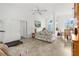 Living room with tiled floors, a sofa, and access to the dining area at 6225 Hancock Ave, Spring Hill, FL 34608