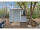 Gray storage shed with ramp access and small window at 6225 Hancock Ave, Spring Hill, FL 34608