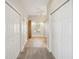 Hallway with tile flooring, built in wooden cabinets and carpet at 7516 Gulf Way, Hudson, FL 34667