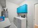 Laundry room with washer, dryer, and bright blue cabinets at 7516 Gulf Way, Hudson, FL 34667