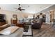 Spacious living room featuring hardwood floors, comfy seating, and a ceiling fan at 7602 Kinnow Ct, Land O Lakes, FL 34637