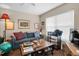 Living room with striped sofa and coffee table, wood floors at 7924 Hardwick Dr # 612, New Port Richey, FL 34653