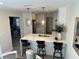 Open concept kitchen with white cabinets, quartz countertops, and breakfast bar at 8448 Foxboro Ln, Spring Hill, FL 34608