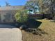 Landscaped side yard with a curved driveway at 8448 Foxboro Ln, Spring Hill, FL 34608