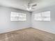 Bright bedroom with carpet and two windows at 8608 Stonehedge Way, Hudson, FL 34667