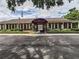 Brick community building with covered entrance and landscaping at 8608 Stonehedge Way, Hudson, FL 34667