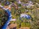 Aerial view showing a single-story house with a pool and a surrounding landscape at 92 Randolph Ave, Spring Hill, FL 34606