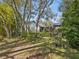Spacious backyard with lush landscaping and a screened enclosure at 92 Randolph Ave, Spring Hill, FL 34606