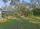Spacious backyard with grassy area and pergola at 92 Randolph Ave, Spring Hill, FL 34606
