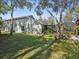 Large backyard featuring a partially visible pool and lush landscaping at 92 Randolph Ave, Spring Hill, FL 34606
