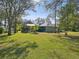 Expansive backyard with a large grassy area and mature trees at 92 Randolph Ave, Spring Hill, FL 34606