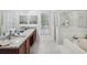 Double vanity bathroom with granite counters, large shower and separate tub at 92 Randolph Ave, Spring Hill, FL 34606
