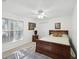 Bedroom with ceiling fan, wood furniture and area rug at 92 Randolph Ave, Spring Hill, FL 34606