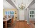 Bright dining room with hardwood floors, a chandelier, and plantation shutters at 92 Randolph Ave, Spring Hill, FL 34606