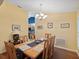 Dining room with hardwood floors, large windows, and a wooden dining table at 92 Randolph Ave, Spring Hill, FL 34606