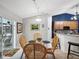 Charming dining area with glass table, wicker chairs, and view of the backyard at 92 Randolph Ave, Spring Hill, FL 34606