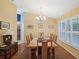 Dining room with hardwood floors, large windows, and a wooden dining table at 92 Randolph Ave, Spring Hill, FL 34606