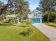 Two-story house with teal garage door and palm trees at 92 Randolph Ave, Spring Hill, FL 34606