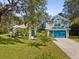 Two-story house with teal garage door and stone accents at 92 Randolph Ave, Spring Hill, FL 34606