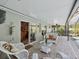Covered patio with wicker furniture and view of pool at 92 Randolph Ave, Spring Hill, FL 34606