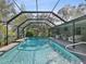 Inviting screened pool with a waterfall feature and patio furniture at 92 Randolph Ave, Spring Hill, FL 34606