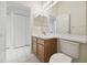 Simple bathroom with a toilet, vanity, and large mirror at 11644 Spindrift Loop, Hudson, FL 34667