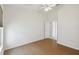 Bright bedroom featuring wood floors and a window with blinds at 11644 Spindrift Loop, Hudson, FL 34667