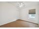Spacious bedroom with wood flooring and a ceiling fan at 11644 Spindrift Loop, Hudson, FL 34667