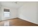 Well-lit bedroom with wood floors and a large window at 11644 Spindrift Loop, Hudson, FL 34667