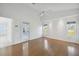 Large bedroom with wood floors, ceiling fan, and access to a patio at 11644 Spindrift Loop, Hudson, FL 34667