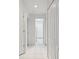 Clean hallway with tile floors and multiple doors leading to other rooms at 11644 Spindrift Loop, Hudson, FL 34667