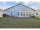 House exterior with sunroom and manicured lawn at 11644 Spindrift Loop, Hudson, FL 34667
