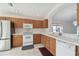 Oak kitchen cabinets, white appliances and tile floor at 11644 Spindrift Loop, Hudson, FL 34667
