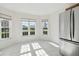 Kitchen nook with windows providing natural light and stainless steel refrigerator at 11644 Spindrift Loop, Hudson, FL 34667