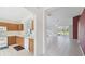 Kitchen with oak cabinets, white appliances, and view into living area at 11644 Spindrift Loop, Hudson, FL 34667