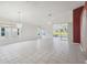 Spacious living room with tile floor, sliding doors to lanai, and red accent wall at 11644 Spindrift Loop, Hudson, FL 34667