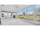 Bright sunroom with golf course view and tile flooring at 11644 Spindrift Loop, Hudson, FL 34667