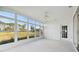 Sunroom with golf course view and ceiling fan at 11644 Spindrift Loop, Hudson, FL 34667