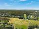 Aerial view of a community nestled next to lush green golf course at 121 Lindsay Ln # 31, Oldsmar, FL 34677
