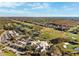 Sweeping aerial view of the community, highlighting the lush golf course, serene ponds, and meticulously maintained landscaping at 121 Lindsay Ln # 31, Oldsmar, FL 34677