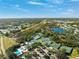 Aerial view of tennis courts, a swimming pool, and meticulously maintained grounds at 121 Lindsay Ln # 31, Oldsmar, FL 34677