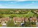 Community aerial view showcases lush landscaping and a nearby golf course at 121 Lindsay Ln # 31, Oldsmar, FL 34677